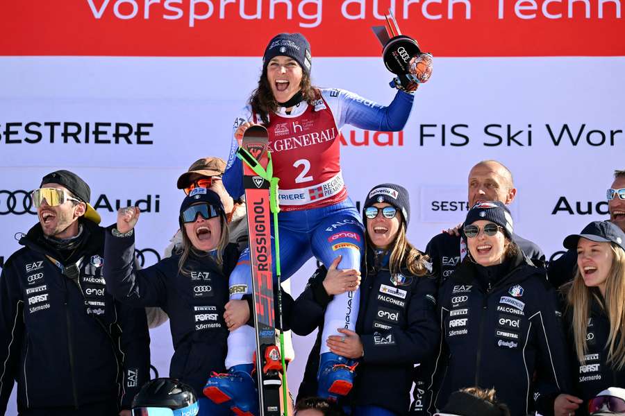 Federica Brignone celebrates with her team after winning the women's giant slalom at the Alpine Skiing World Cup in Sestriere on Friday