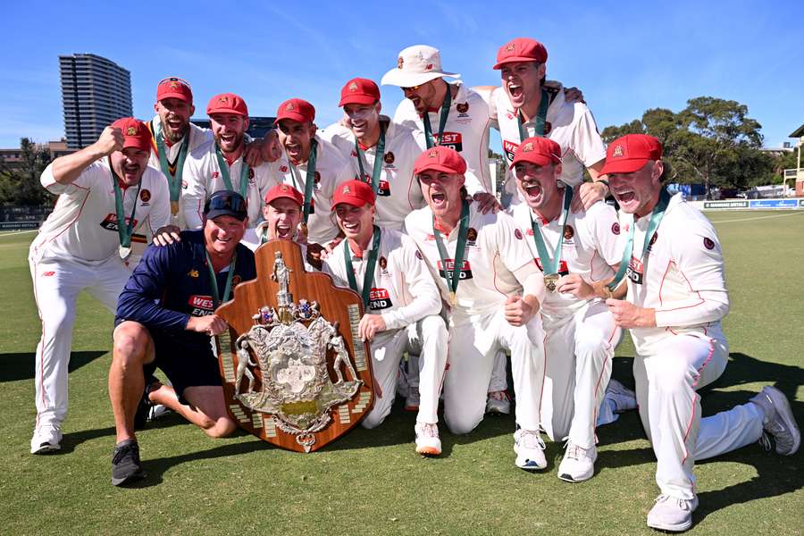 South Australia's players pose with the Sheffield Shield trophy in Melbourne.