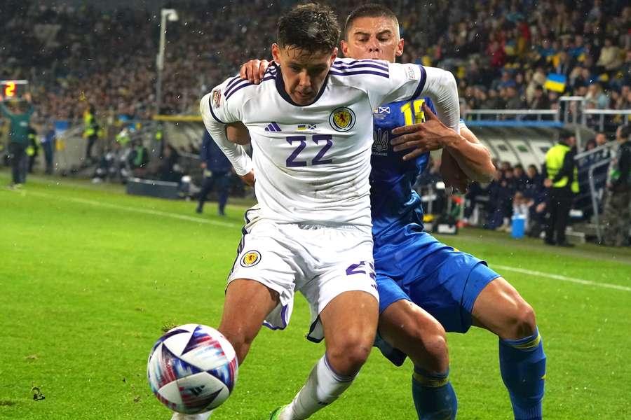 Scotland's defender Aaron Hickey (front) and Ukraine's defender Vitaliy Mikolenko vie for the ball