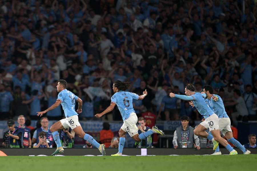 Rodri and his teammates celebrate after the goal