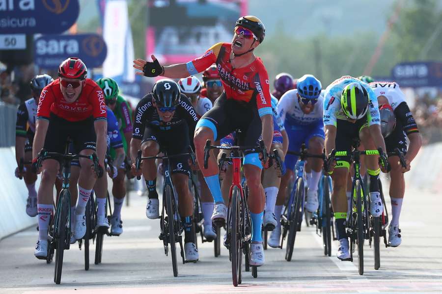 Jonathan Milan (C) celebrates as he crosses the finish line to win the second stage of the Giro d'Italia 2023 cycling race,