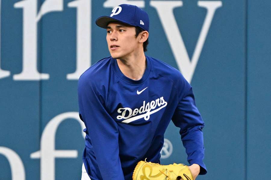 Dodgers pitcher Roki Sasaki warms up prior to Game 3 of the NLDS against the Philadelphia Phillies