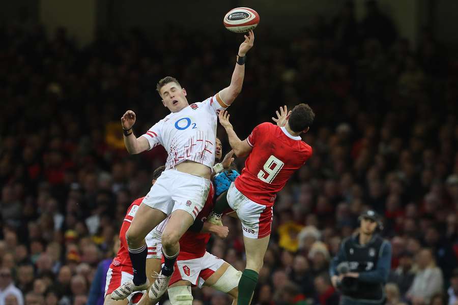 England's full-back Freddie Steward jumps above Wales' scrum-half Tomos Williams 