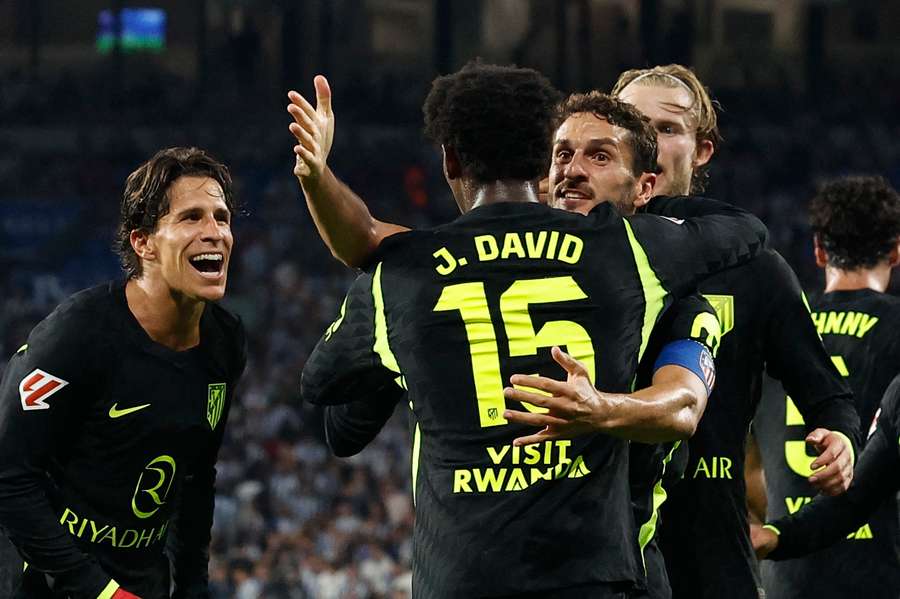 Jonathan David is congratulated after his scoring his first Atletico goal