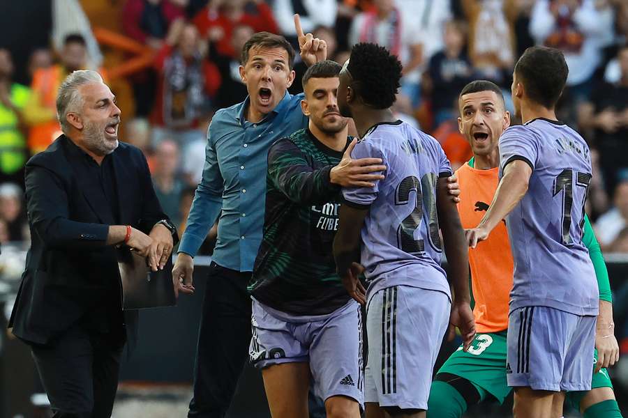 eal Madrid's Brazilian forward Vinicius Junior (3R) confronts Valencia's officials as he leaves after being sent off the pitch