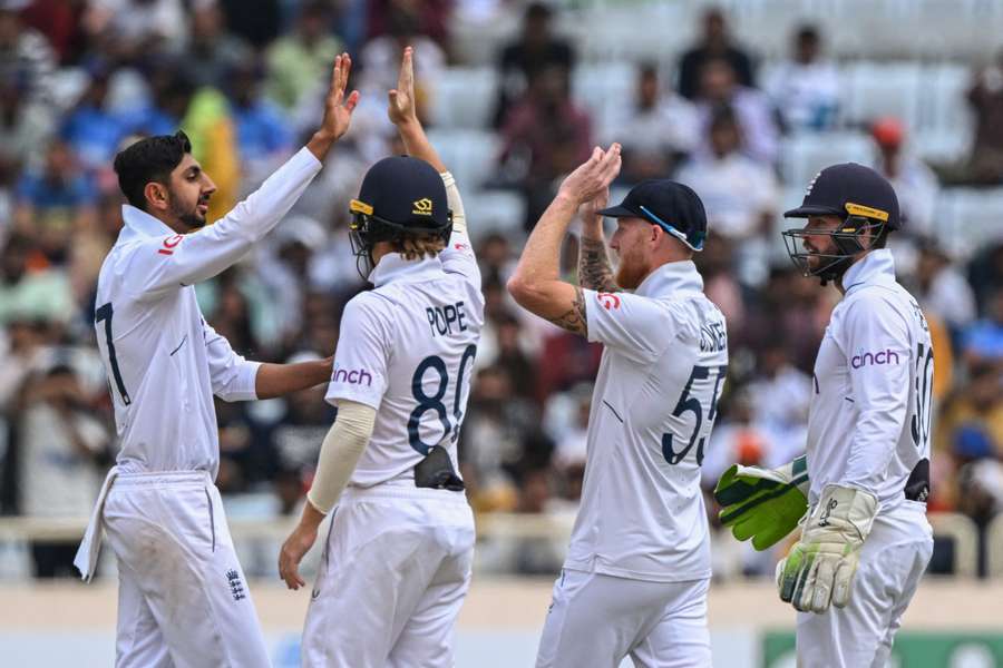 England's Shoaib Bashir celebrates with Ollie Pope, captain Ben Stokes and Ben Foakes after taking the wicket of India's Akash Deep