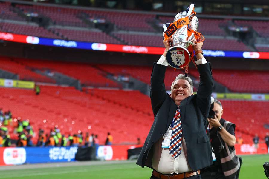 Luton Town CEO Gary Sweet celebrates with the trophy 