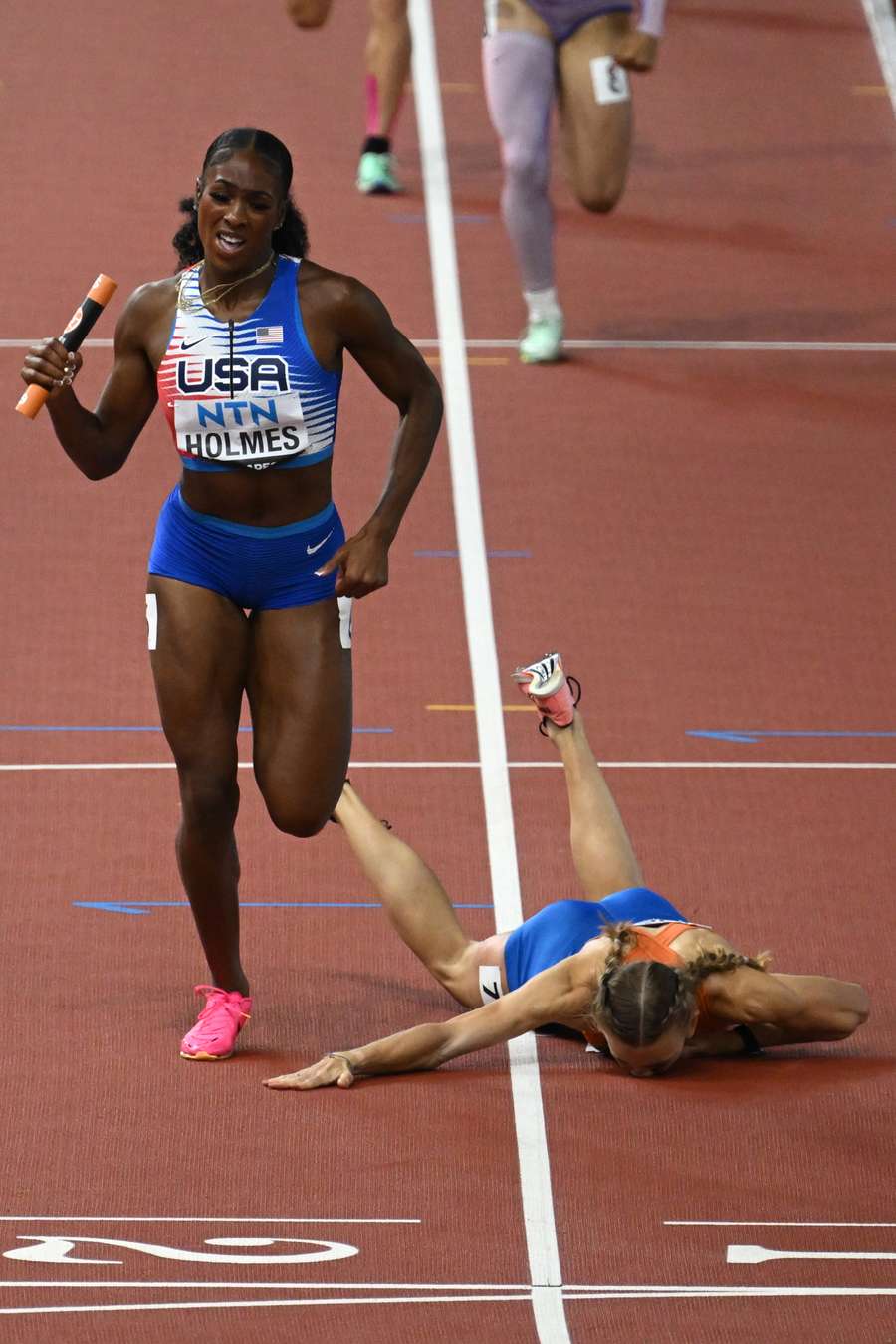 The Netherlands' Femke Bol falls the floor as USA win gold