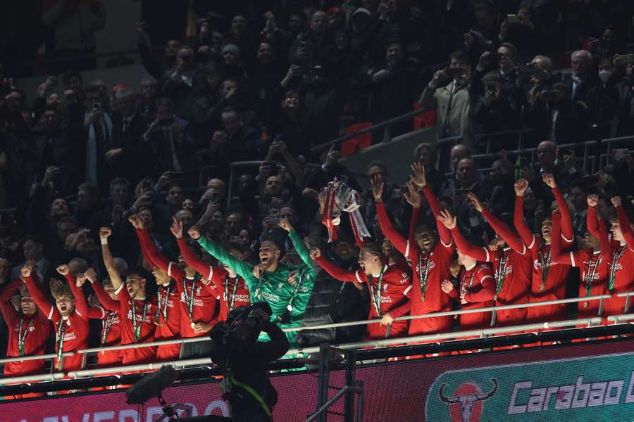 Virgil Van Dijk lifts the EFL Cup for Liverpool