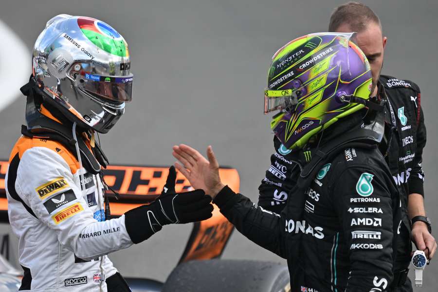 Third placed Mercedes' British driver Lewis Hamilton (R) and second placed McLaren's British driver Lando Norris