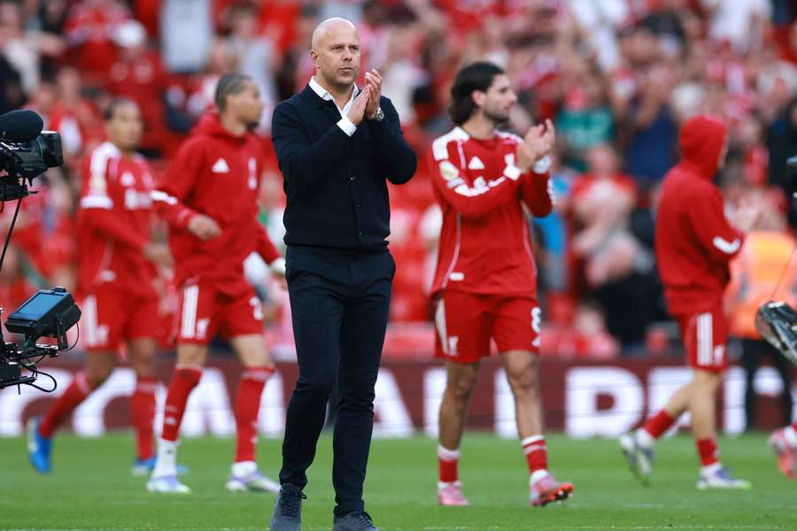 Arne Slot applauds Liverpool's fans after their victory at Anfield