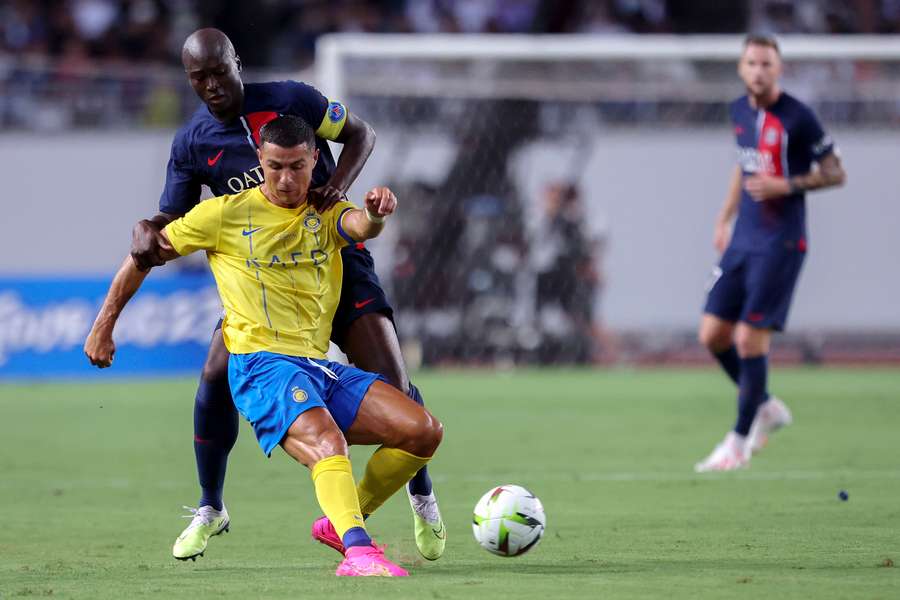 Paris Saint-Germain's Danilo Pereira (back) fights for the ball with Al-Nassr's Cristiano Ronaldo