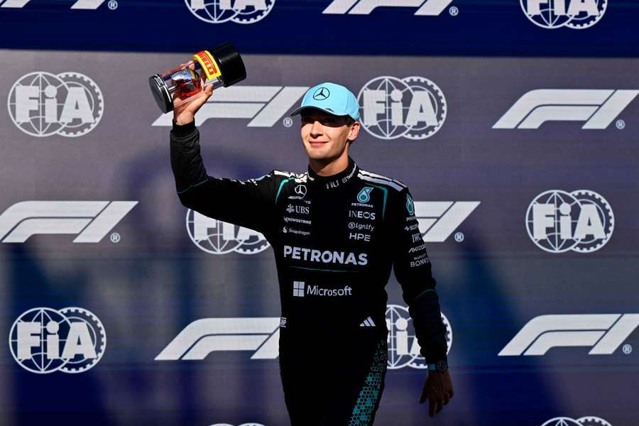 George Russell celebrates taking pole