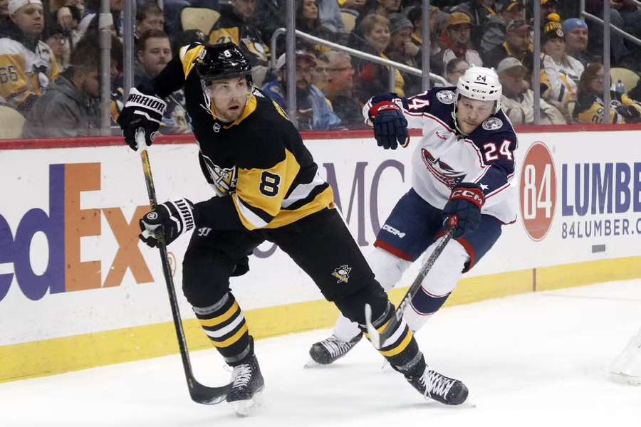 Pittsburgh's Brian Dumoulin takes the puck away from Columbus' Mathieu Olivier