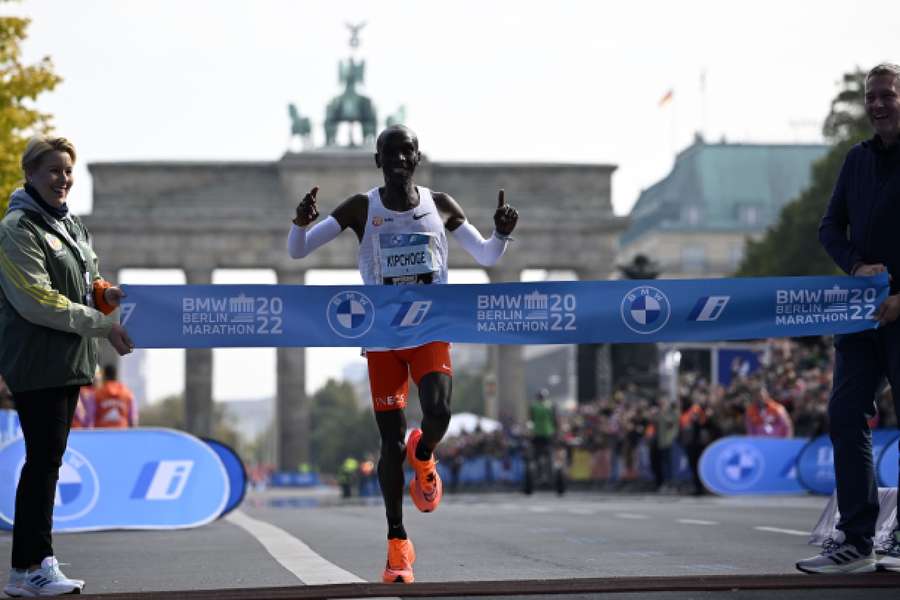 Kipchoge cruza la meta tras dejar atrás la Puerta de Brandenburgo