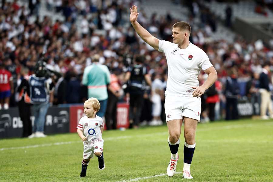 England's fly-half and captain Owen Farrell applauds supporters