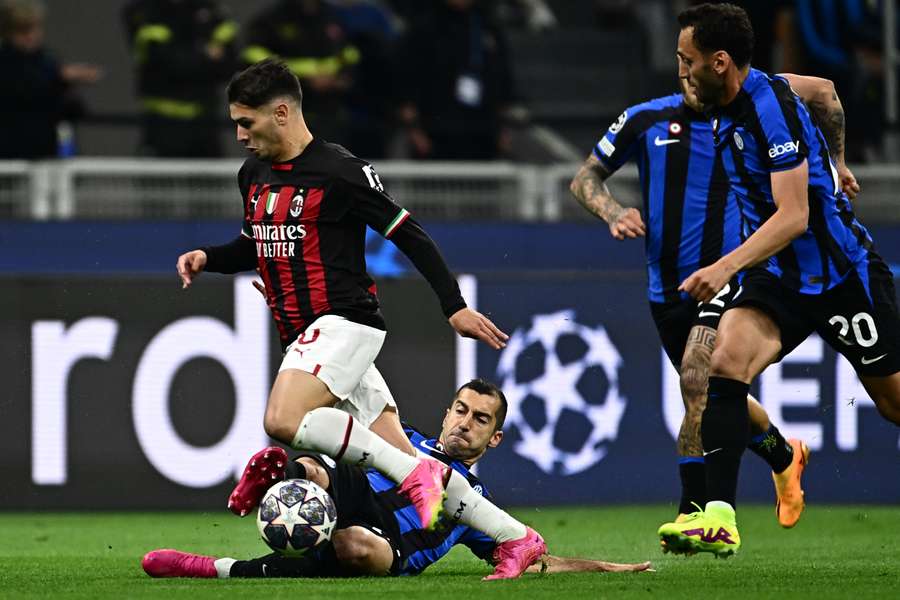 Henrikh Mkhitaryan tackles AC Milan's Brahim Diaz