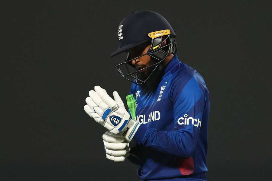 England's Adil Rashid walks after losing his wicket, caught by Afghanistan's Mohammad Nabi off the bowling of Rashid Khan