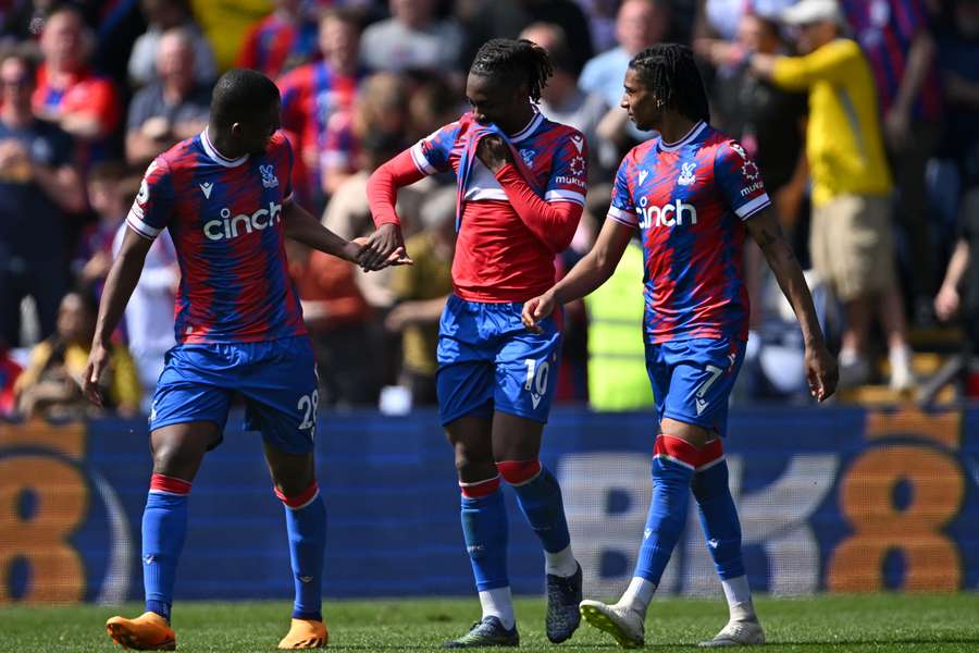 Crystal Palace's English midfielder Eberechi Eze (C) celebrates with teammates after scoring their fourth goal from the penalty spot