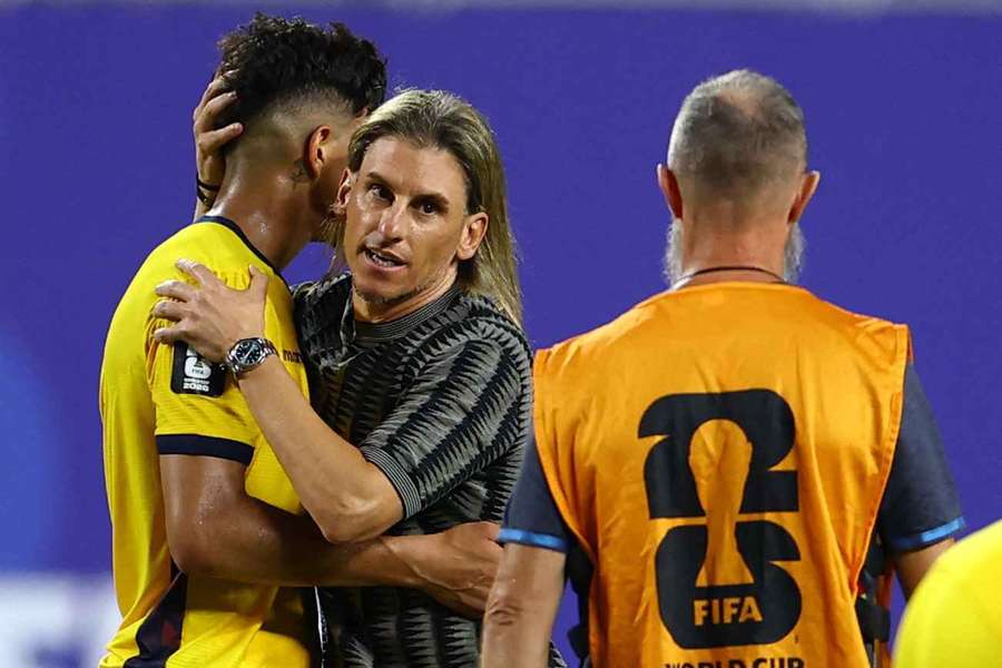 Ecuador head coach Sebastian Beccacece consoles Piero Hincapie after their last match.