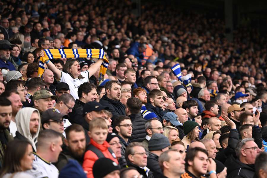 A Leeds fan holds up a scarf in the crowd ahead of the Premier League match between Leeds United and Manchester United