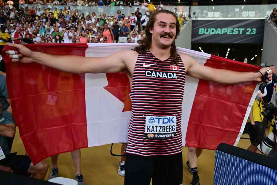 Ethan Katzberg celebrates after winning gold in the hammer throw