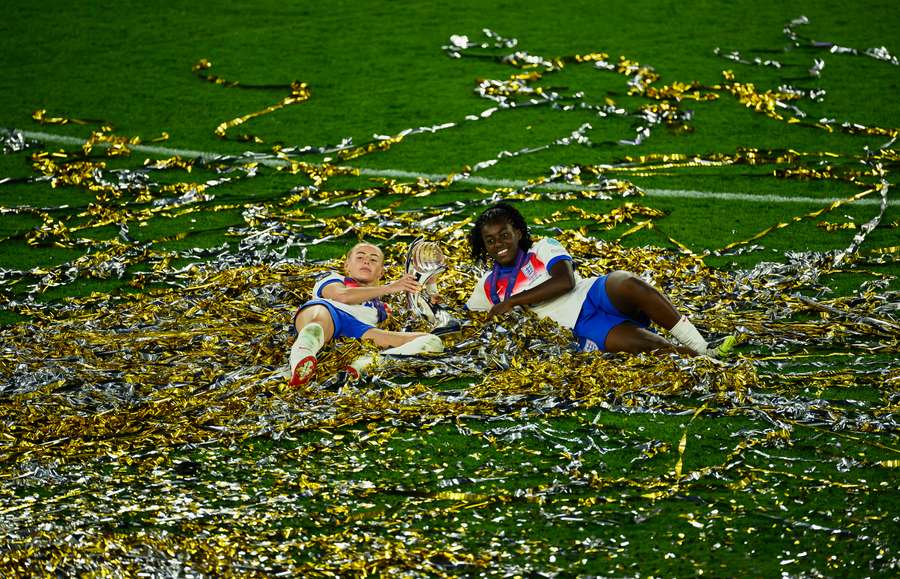 Chloe Kelly and Michelle Agyemang of England celebrate with the trophy after their team's victory in the Women's Euro 2025 final