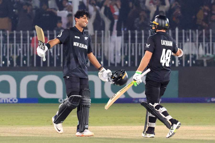 New Zealand's Rachin Ravindra celebrates reaching his century with Tom Latham