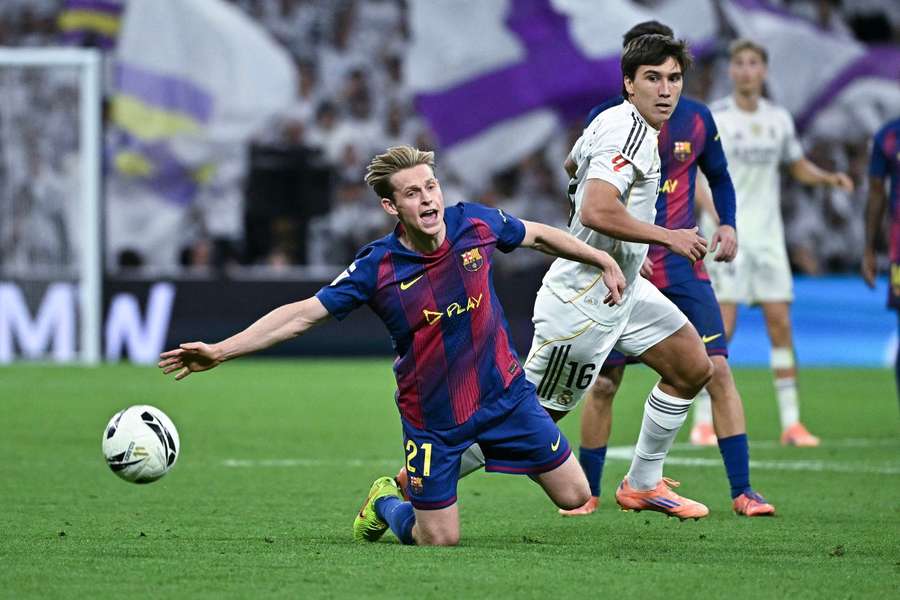 Barcelona's Frenkie De Jong is challenged by Real Madrid's Gonzalo Garcia