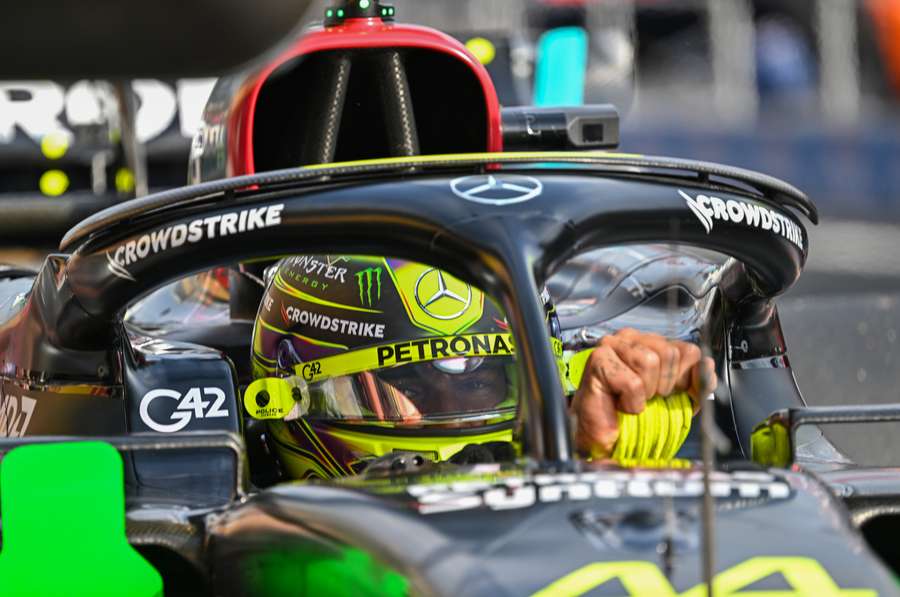 Lewis Hamilton adjusts his gloves during the second practice session at the Hungaroring race track