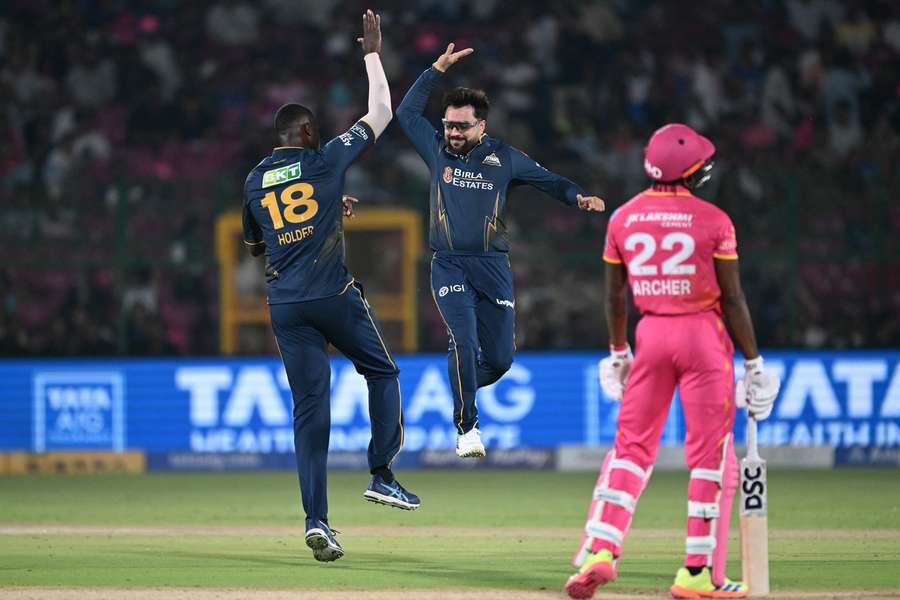 Rashid Khan (R) celebrates with Jason Holder (L)