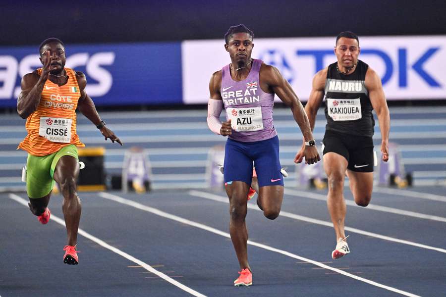 Jeremiah Azu sprints past Julian Forde and Arthur Cissé to win his 60m heat at the World Indoor Championships in Nanjing on Friday