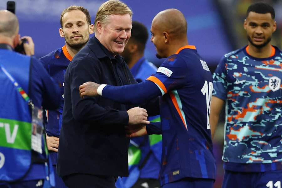 Netherlands' Donyell Malen and coach Ronald Koeman celebrate after the match