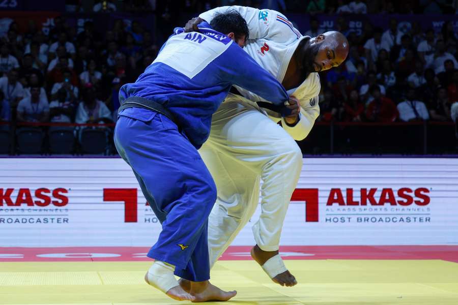 Russia's Inal Tasoev (blue) competes against France's Teddy Riner during the men's +100Kg final bout