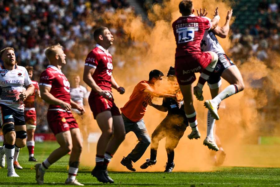 The protester runs onto the pitch