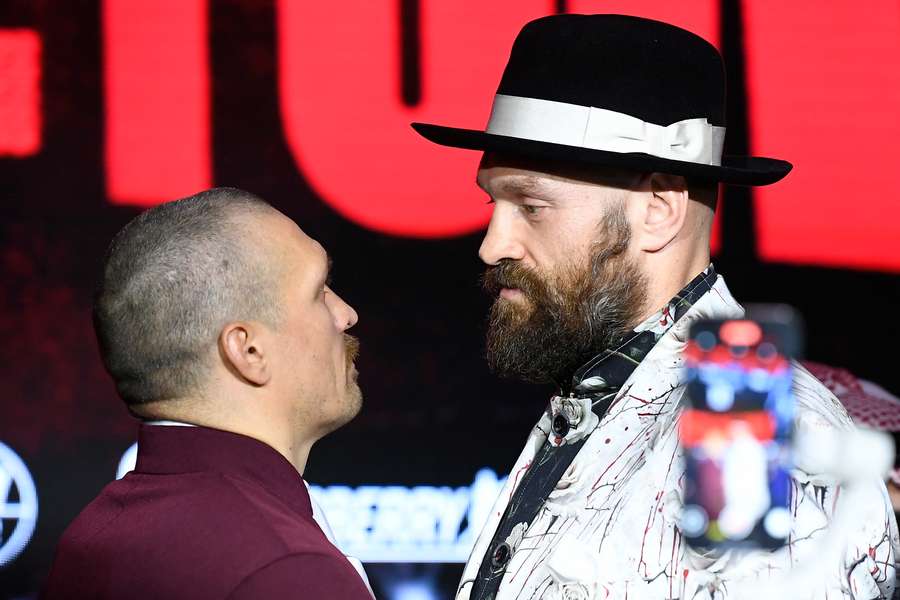 Britain's Tyson Fury (R) and Ukraine's Oleksandr Usyk face off during a press conference