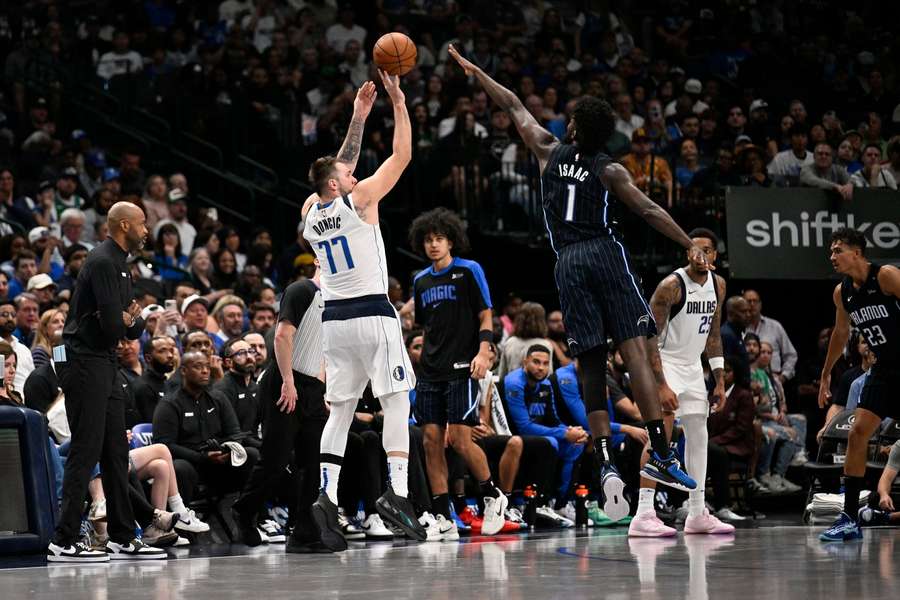 Dallas Mavericks guard Luka Doncic shoots over Orlando Magic forward Jonathan Isaac