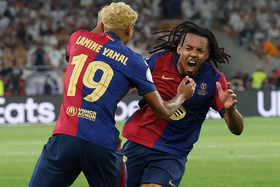 Barcelona's Jules Kounde celebrates scoring the winning goal with Lamine Yamal