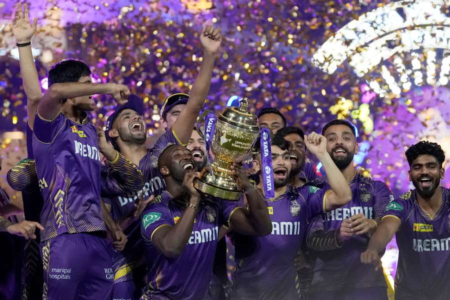 Kolkata Knight Riders players celebrate with the trophy after defeating Sunrisers Hyderabad during the IPL final in 2024