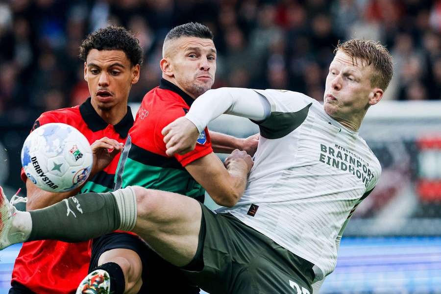 PSV captain Jerdy Schouten duels with NEC's Bryan Linssen