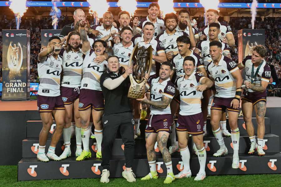 Brisbane Broncos' players celebrate with the trophy after winning the National Rugby League (NRL) Grand Final 
