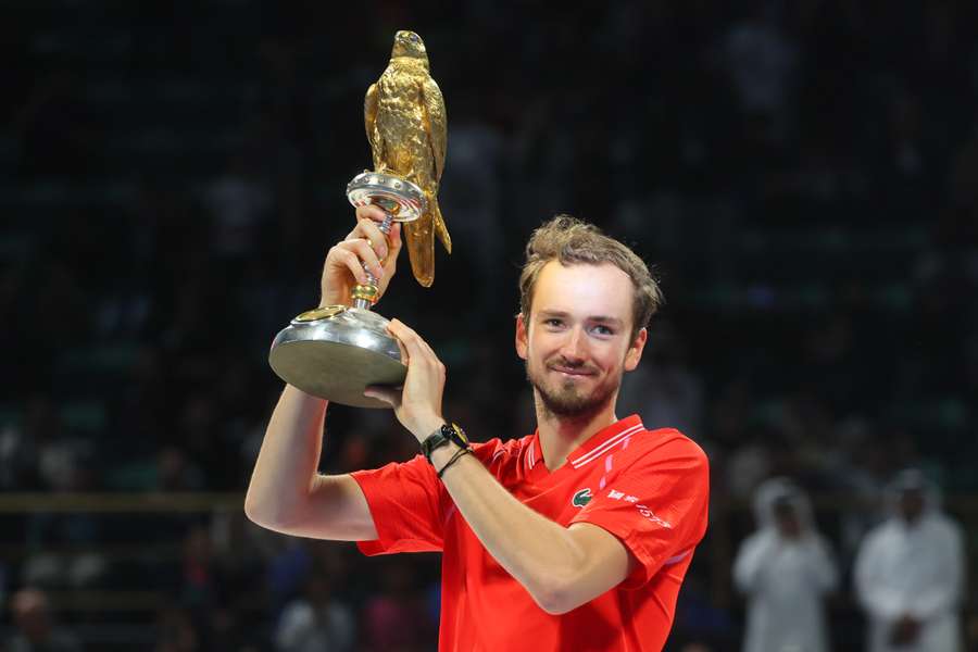 Russia's Daniil Medvedev celebrates on the podium with his trophy