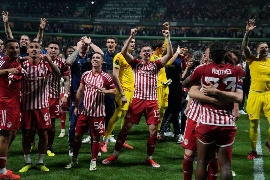 Olympiacos players celebrate after the final whistle
