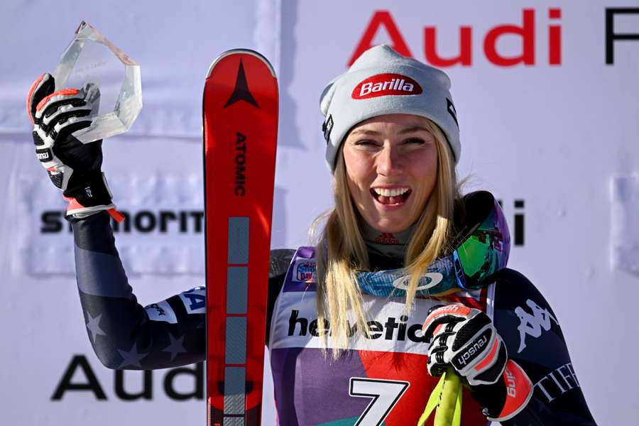 Mikaela Shiffrin celebrates with the winner's trophy of the FIS alpine skiing Women's World Cup event in Saint Moritz.