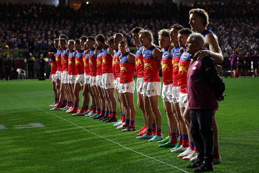 Brisbane Lions players and coach Chris Fagan line up for the national anthem during their Qualifying Final loss to Geelong.