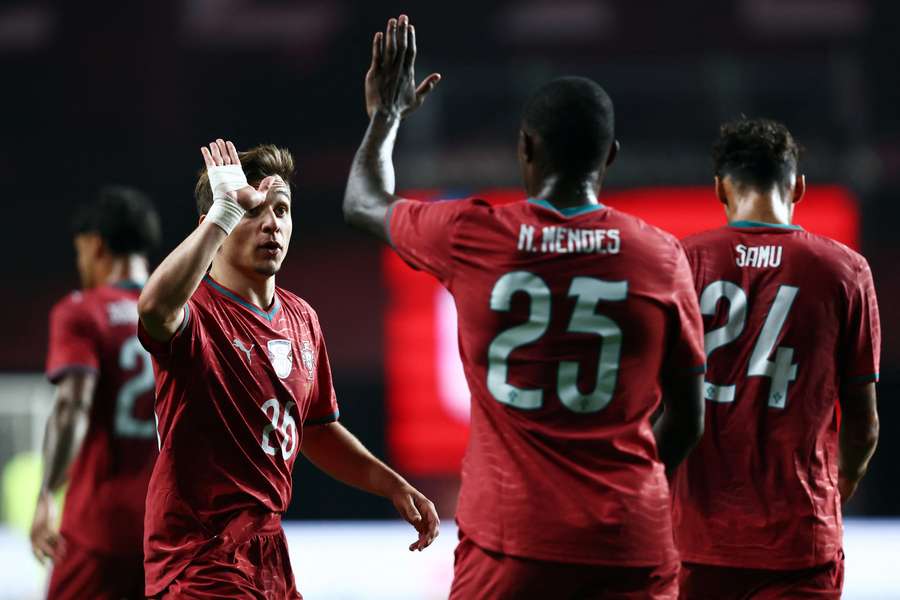 Francisco Conceicao celebrates with Nuno Mendes
