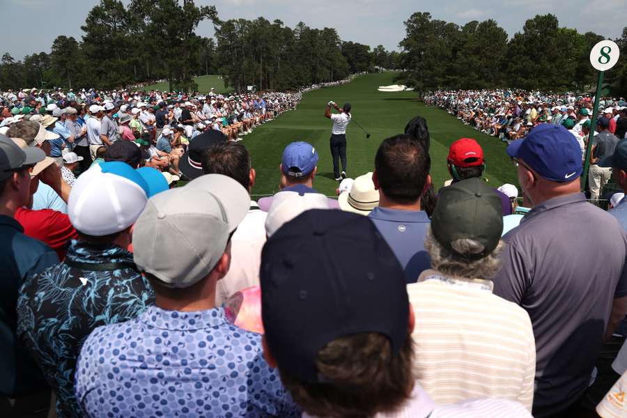 Tiger Woods plays his shot from the eighth tee