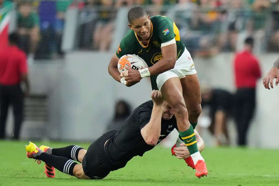 South Africa's Manie Libbok tries to break a tackle