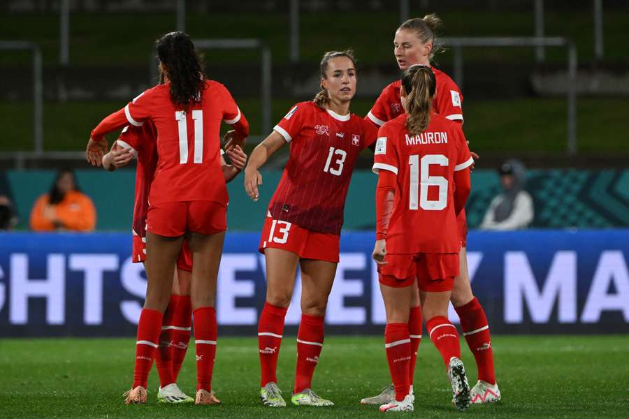 Switzerland's midfielder #13 Lia Walti (C) and teammates react at the end of the match between Switzerland and Norway