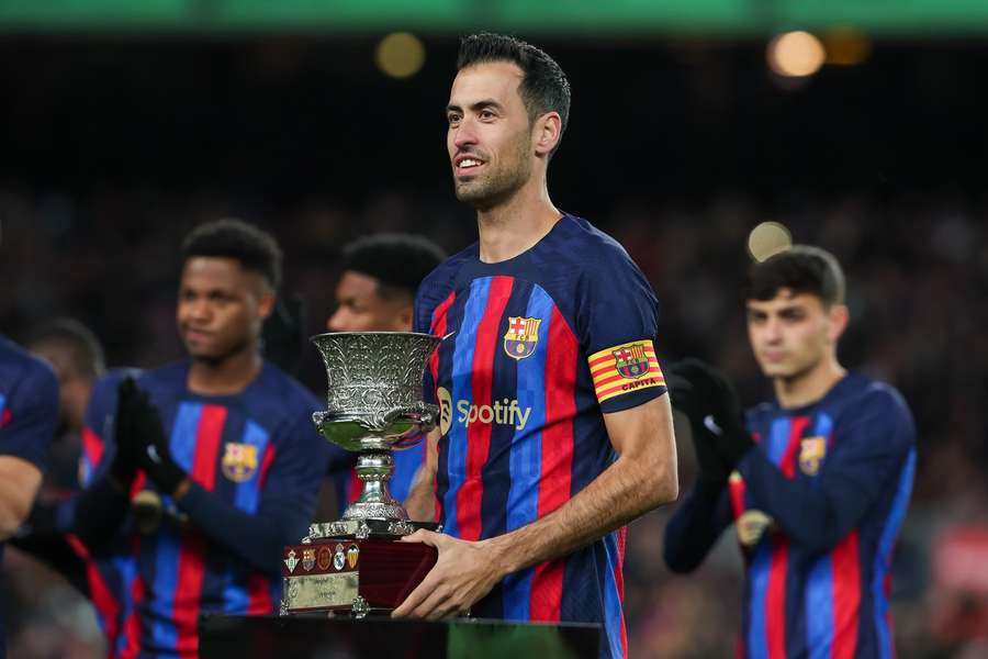 Sergio Busquets holds the Super Copa trophy after Barcelona beat Real Madrid in the final